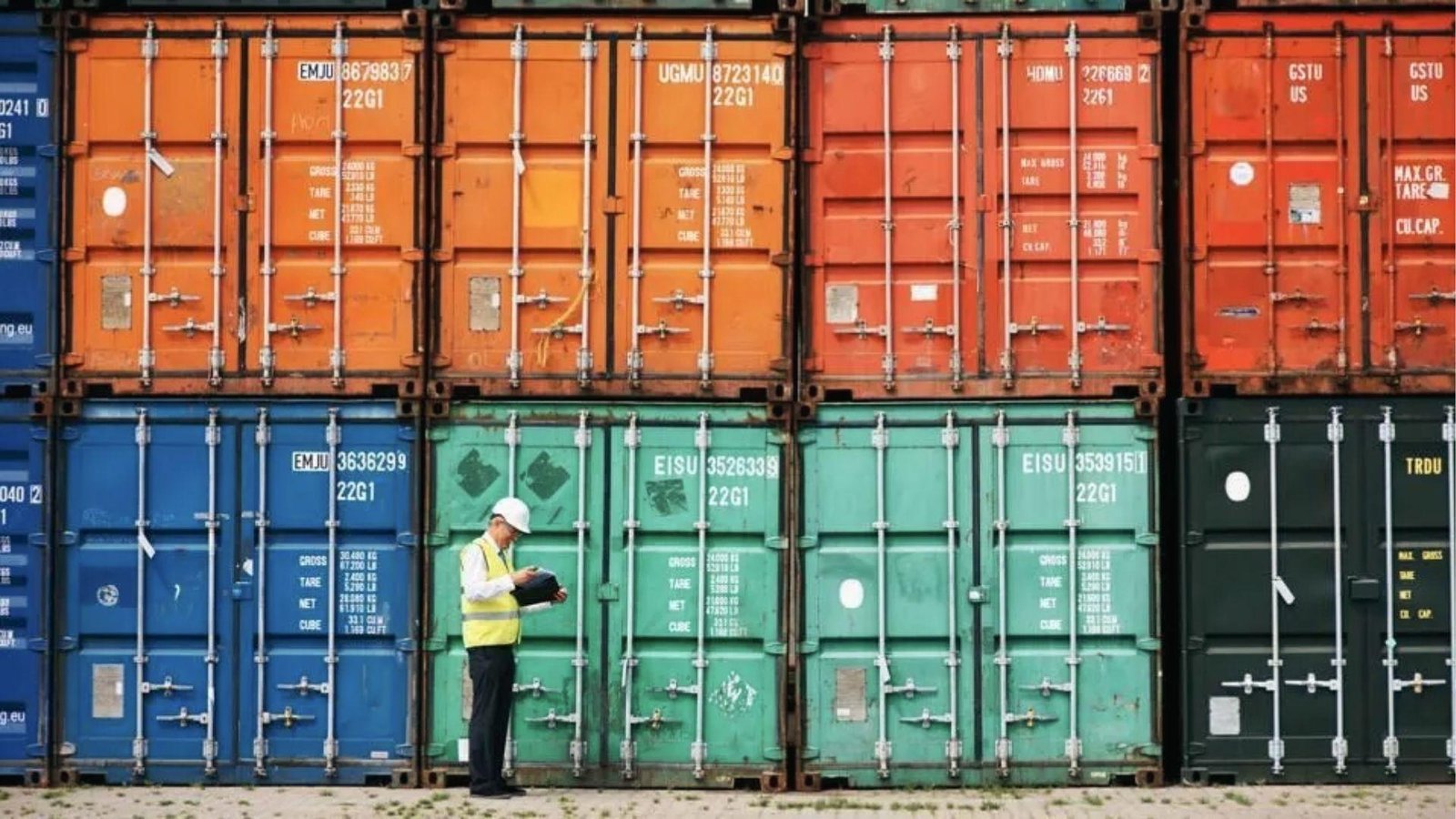 Worker checks stacked containers with clipboard, showing survey fees in moving container guide.