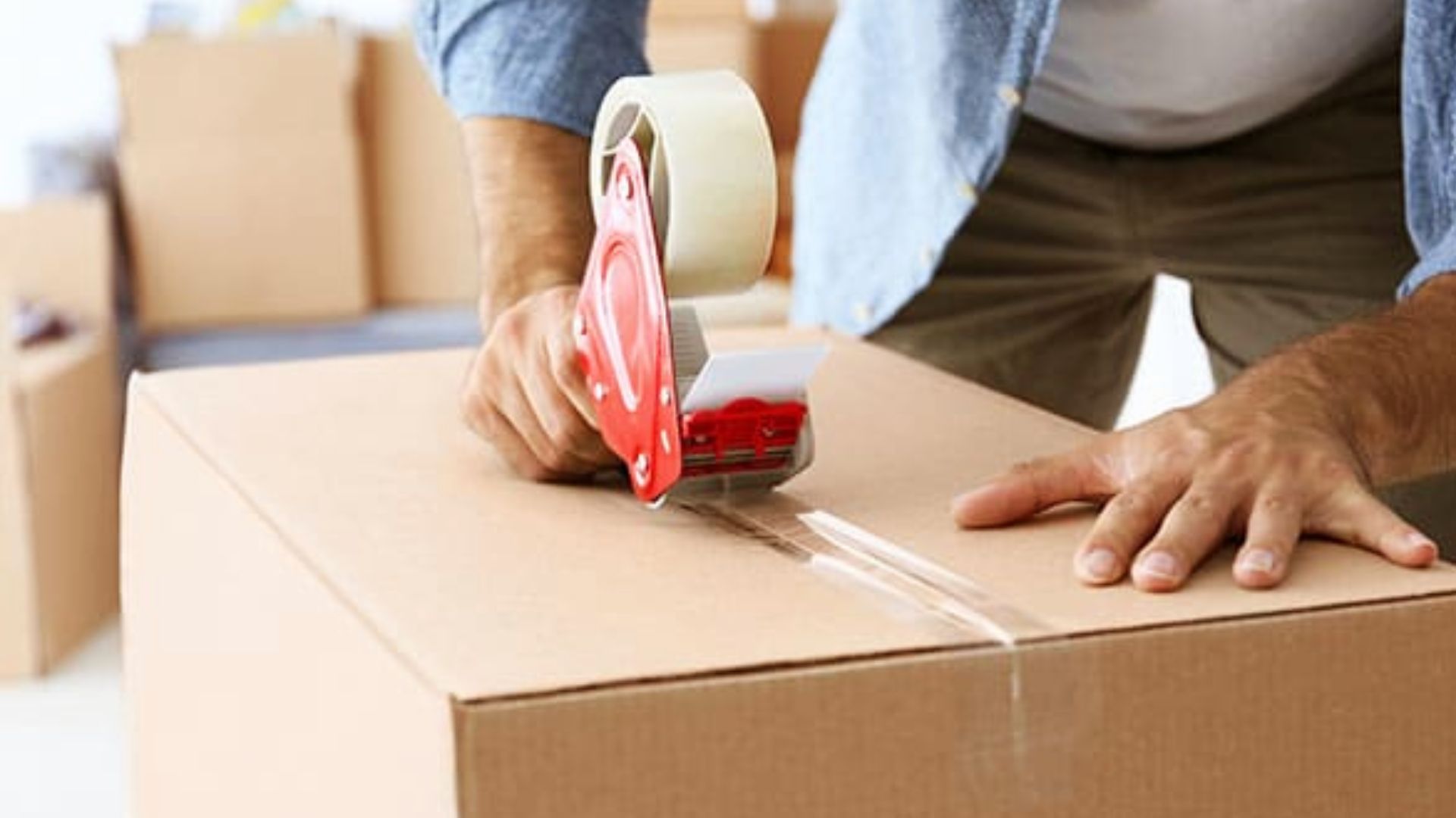  Same cardboard box being sealed on top using H-tape method in consistent moving packing setup.