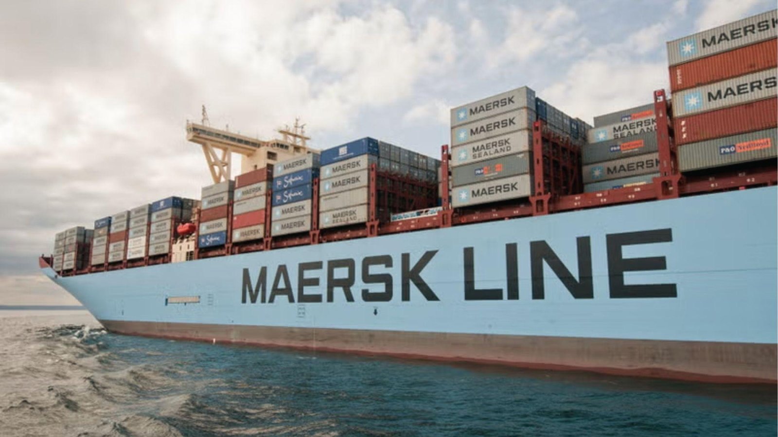 Maersk Line container ship at sea loaded with stacked containers under cloudy skies, among largest vessels