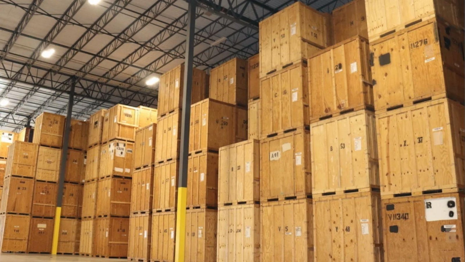Stacked wooden crates in secure warehouse facility used by movers for long-term storage of household goods