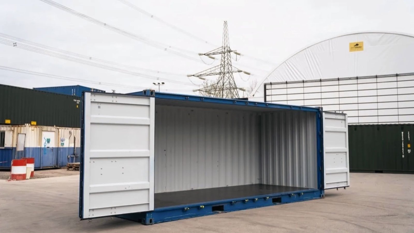 Blue open-side shipping container with both side doors fully open at a storage yard.